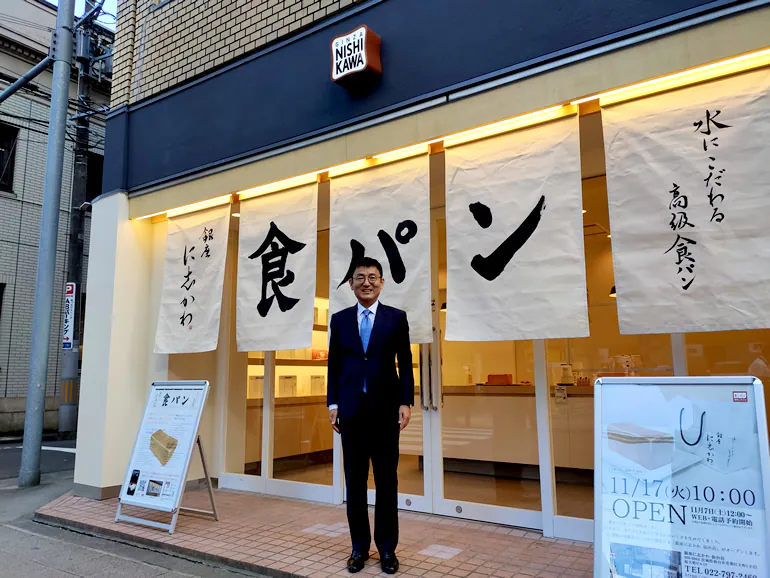 髙橋社長と仙台店外観